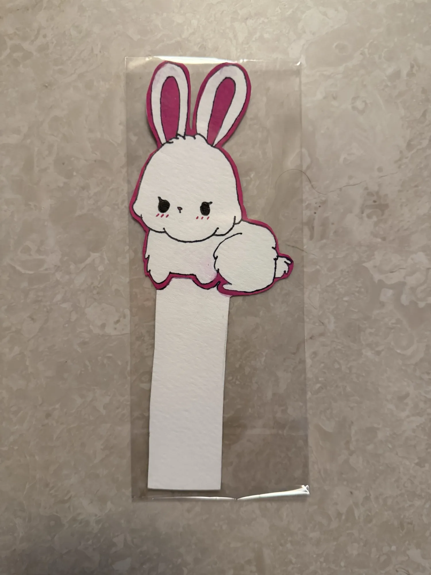 Painted bookmark resting in a book